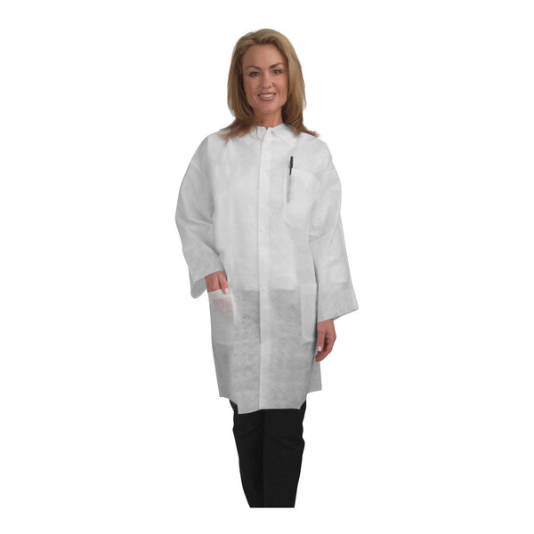 A woman wearing a white Cordova heavy weight polypropylene lab coat with elastic wrists.