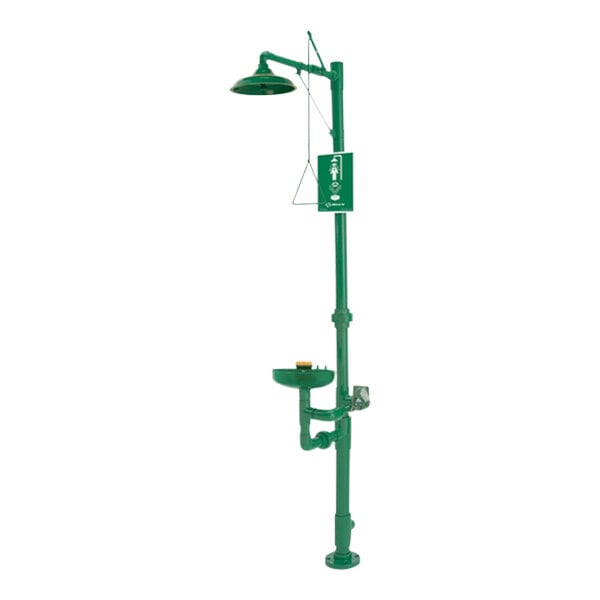 A green Haws emergency shower head and faucet with a green pipe.