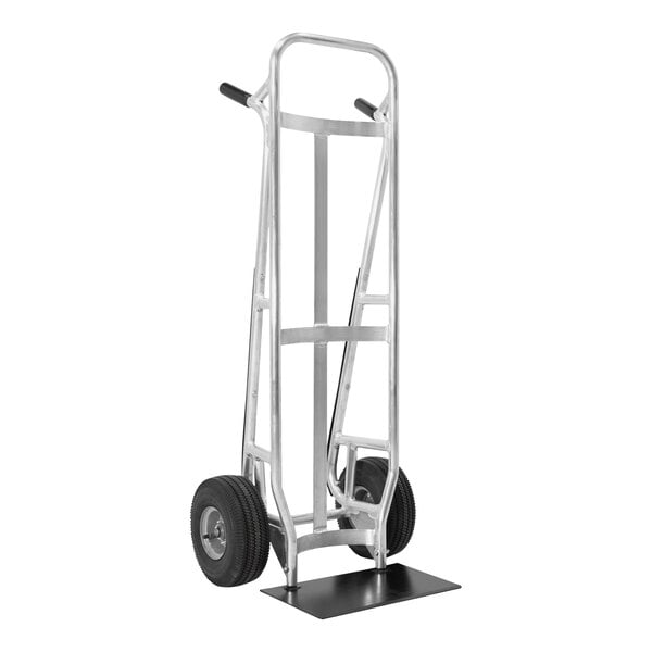 A silver hand truck with a black curved back and wheels.