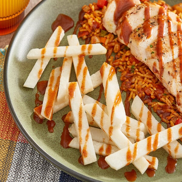 A plate of food with Tajin Chamoy sauce on it.