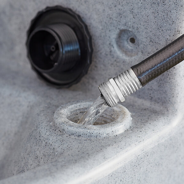 A hose connected to a Lavex mobile hand wash station faucet.