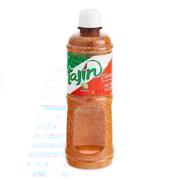 A close up of a jar of Tajin Classic seasoning on a white background.