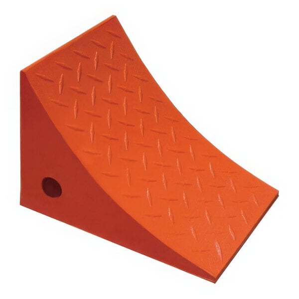 An orange urethane wheel chock with a hole in it.