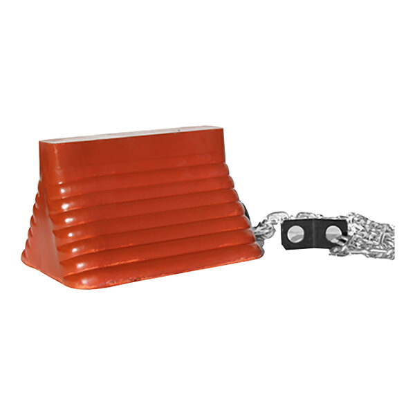 A close-up of a red molded rubber wheel chock with a chain attached.