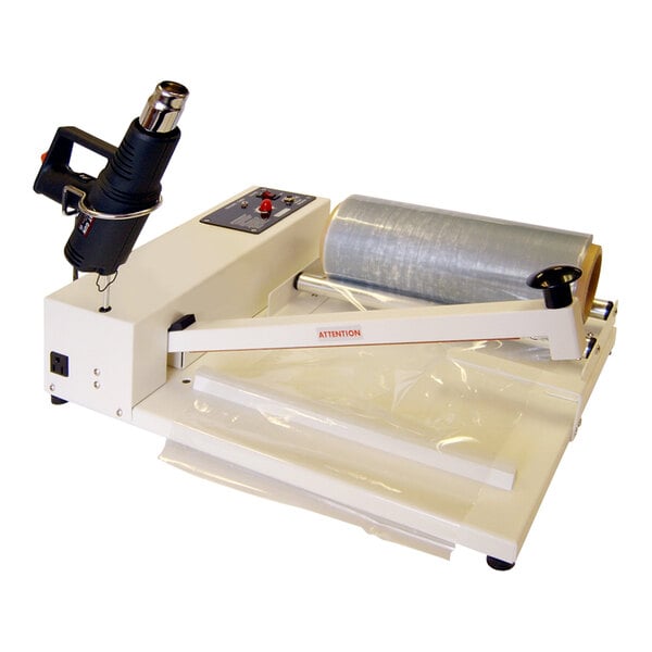 A Sealer Sales shrink wrapping machine with plastic roll and a plastic bag being sealed.