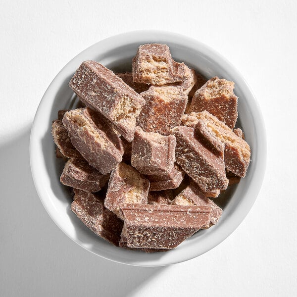 A white bowl filled with chopped pieces of KIT KAT chocolate bars.