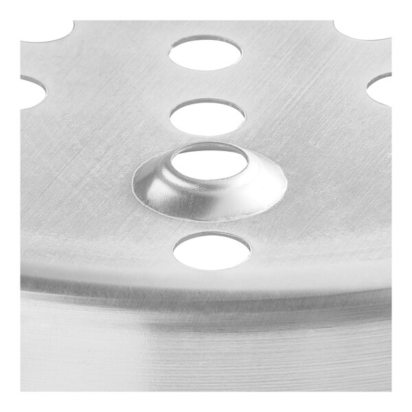 An aluminum steamer basket with holes in it.
