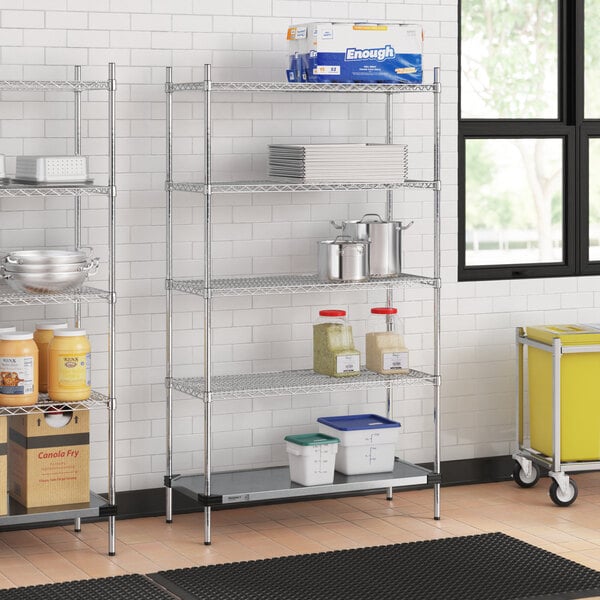 A Regency metal wire shelving unit in a kitchen with food containers on the shelves.