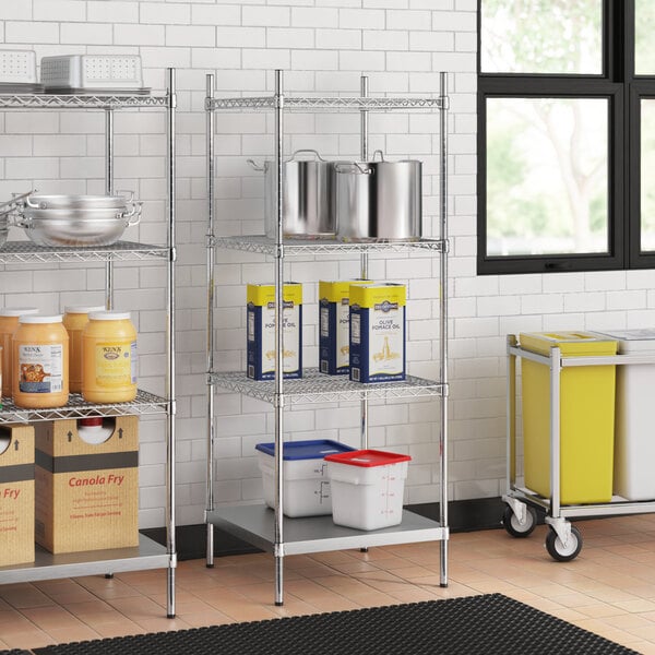 Stainless steel wire shelves with solid bottoms holding white and blue plastic containers with red lids.