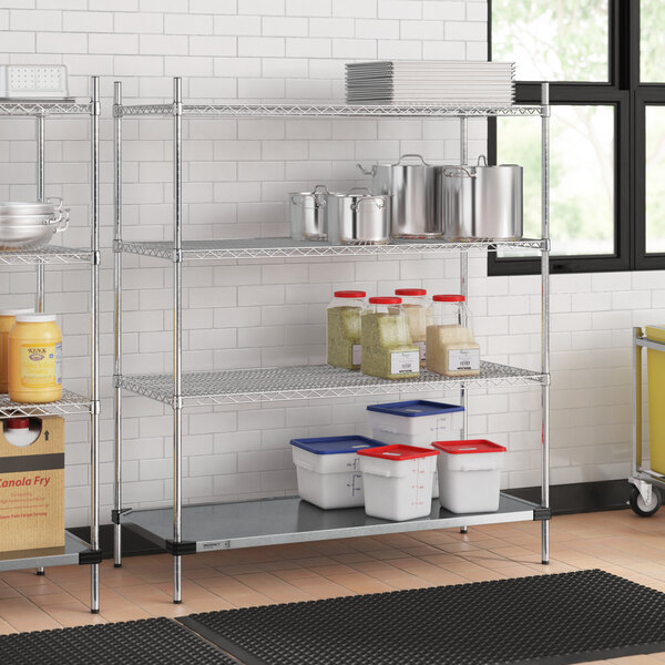 A Regency chrome wire shelving unit in a kitchen with white and red plastic containers on the shelves.