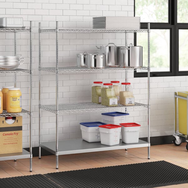 A stainless steel wire shelf unit with white and blue plastic containers on the shelves.