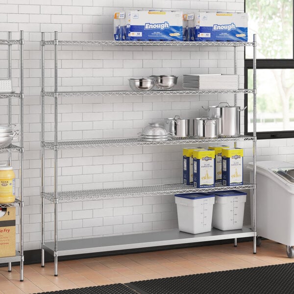 A stainless steel wire shelf unit with solid stainless steel bottom shelves holding food containers.