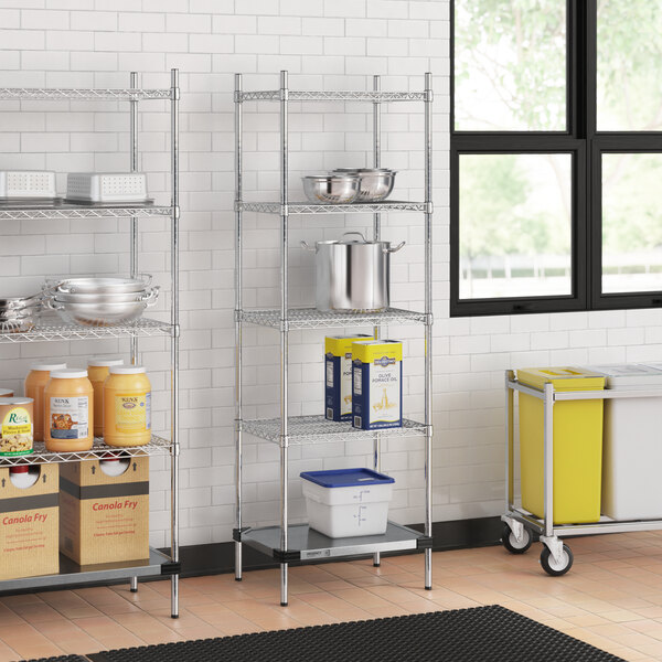 A Regency chrome wire shelving unit in a kitchen with a solid galvanized steel bottom shelf.