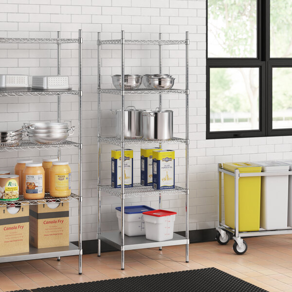 A stainless steel wire shelf kit with 5 shelves and a solid bottom in a kitchen with stainless steel and plastic containers.