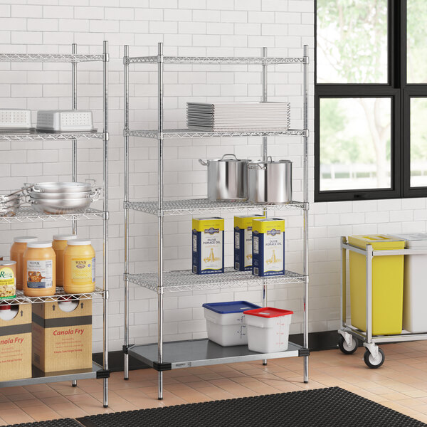 A Regency chrome wire shelving unit in a kitchen with pots and pans on the shelves.