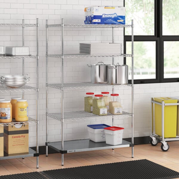 Regency chrome wire shelving with a solid metal bottom shelf in a kitchen with food items on it.