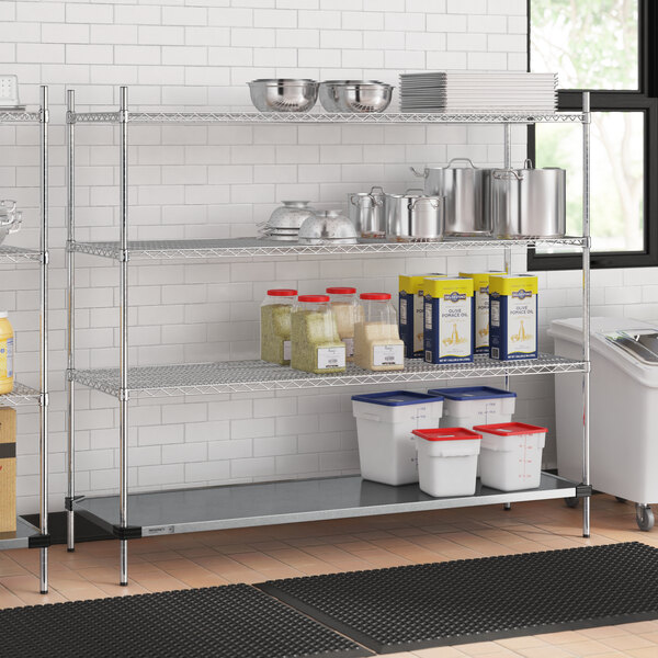 A Regency chrome wire shelving unit in a kitchen with white and blue plastic bins on the shelves.