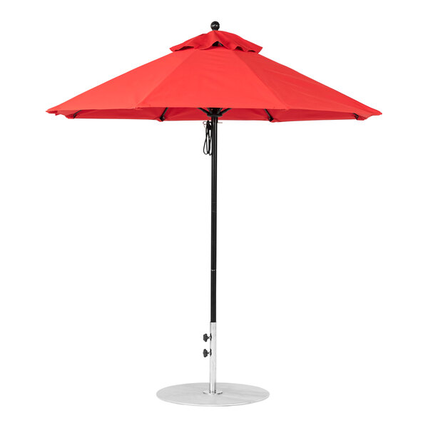 A red BFM Seating umbrella on a black metal pole.