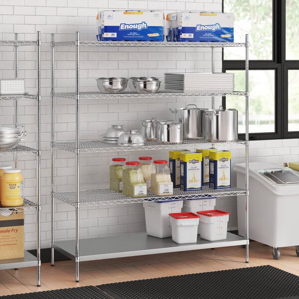 A stainless steel wire shelf kit with 5 shelves on a metal shelving unit holding food containers and pots.