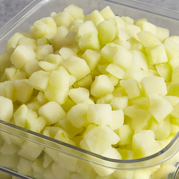 A clear container filled with Dole Chef-Ready Cuts IQF diced apples.