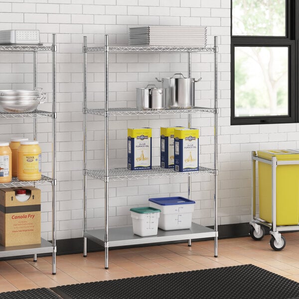 A stainless steel wire shelf unit with stainless steel bottom shelves holding containers.