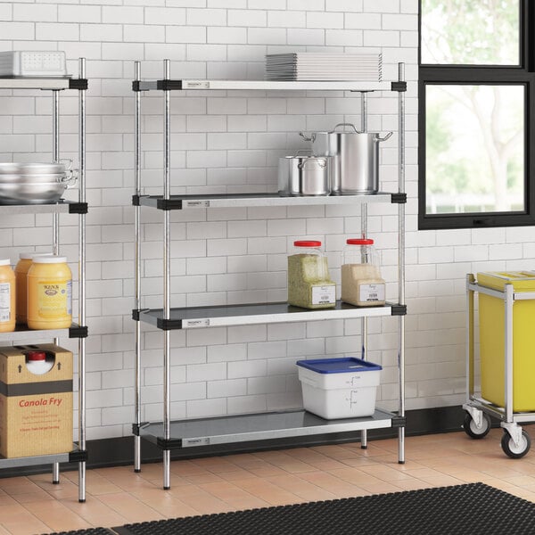 Regency galvanized steel shelves in a professional kitchen with food items on them.