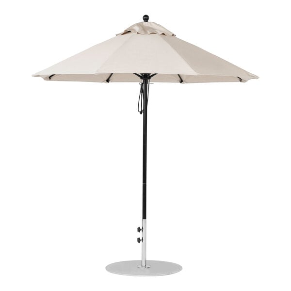A white umbrella with a black pole on a metal stand.