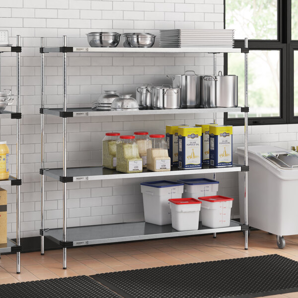 A Regency galvanized steel shelf with food containers on it in a professional kitchen.