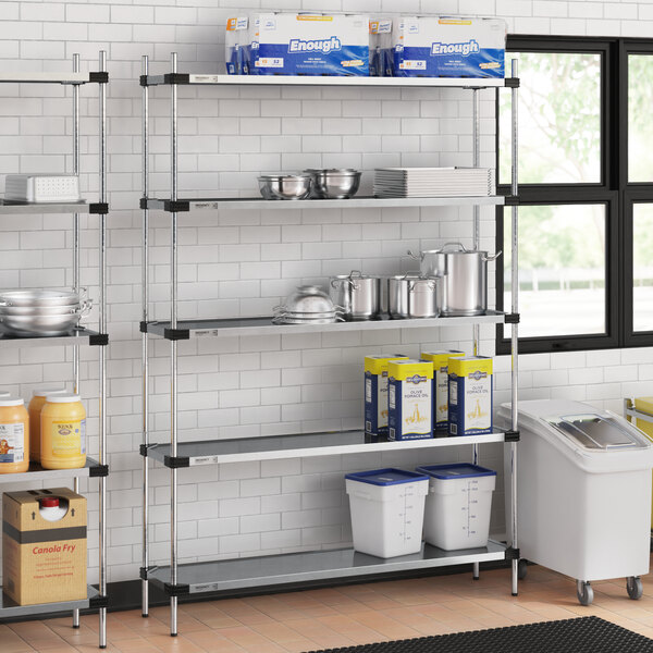 Regency NSF galvanized steel shelves in a school kitchen with pots and pans on them.