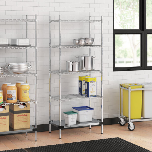 A Regency metal wire shelving unit in a kitchen with containers on the bottom shelf.