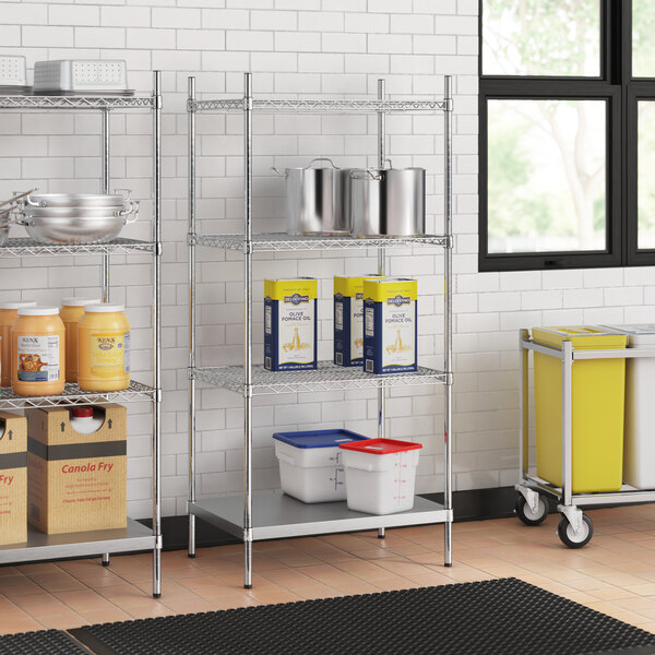 Stainless steel wire shelves with solid stainless steel bottom and white and blue plastic containers with red lids on stainless steel posts.