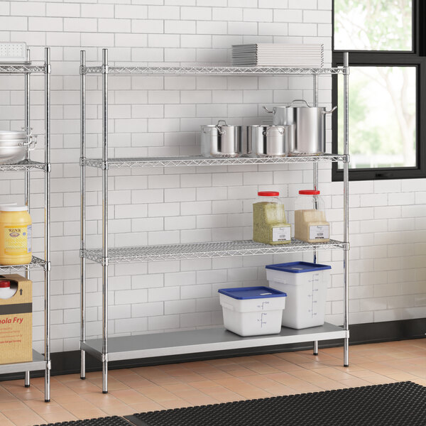 A stainless steel wire shelf kit with 4 shelves in a professional kitchen.