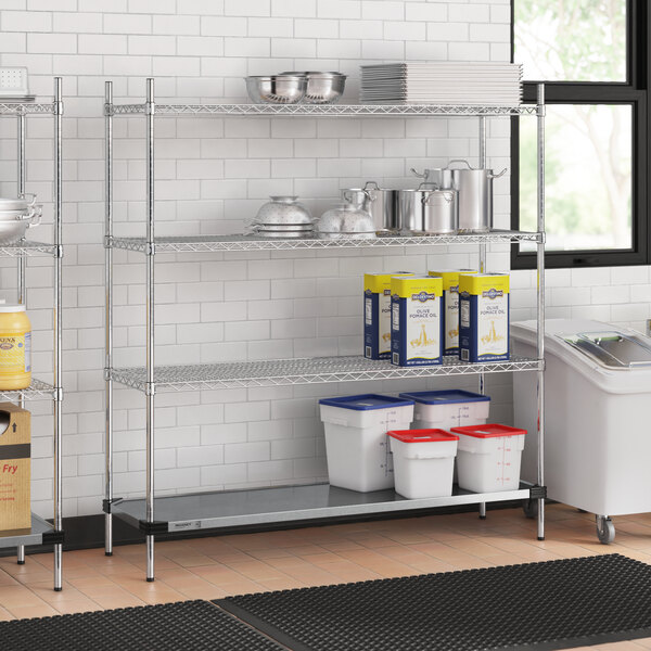 A Regency metal wire shelving unit in a professional kitchen with white containers on the shelves and a white and red container next to it.