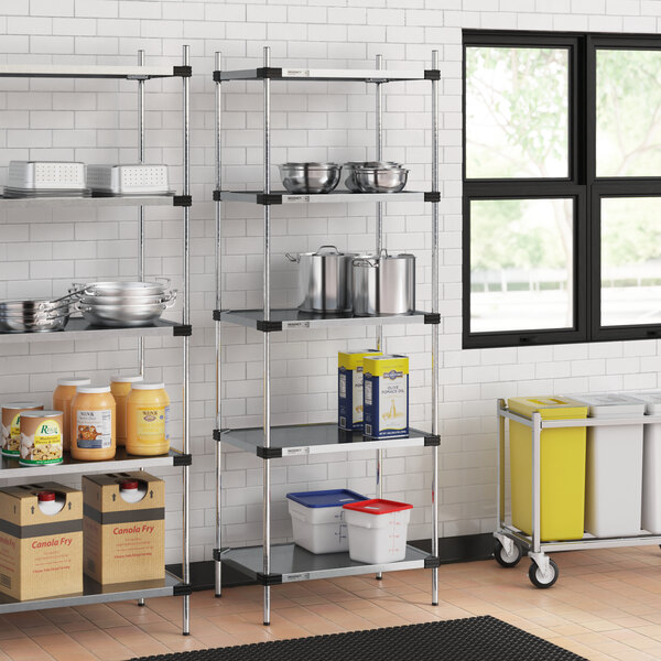 Regency galvanized steel shelves in a kitchen with food containers on them.