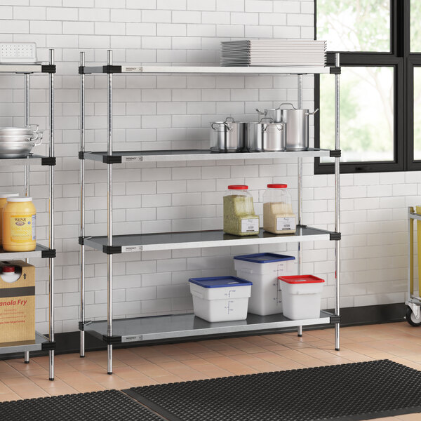 Regency galvanized steel shelving in a professional kitchen with white and blue plastic containers and a white bucket with a red lid.