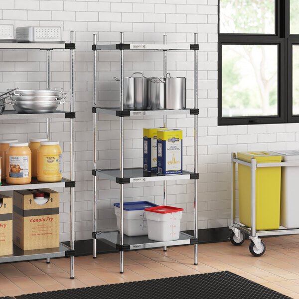 Regency galvanized steel shelves with food containers and buckets on them in a professional kitchen.