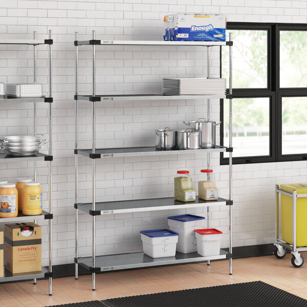 A Regency metal shelving unit in a kitchen with white and blue containers on the shelves.