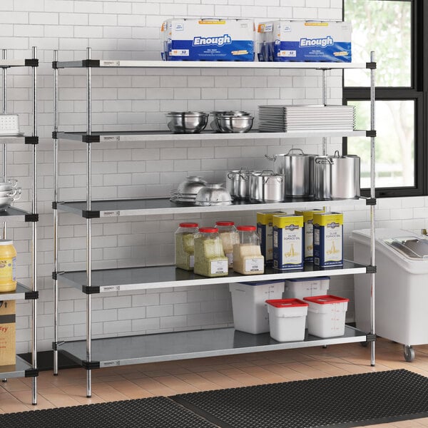 A five-shelf galvanized steel shelving unit with 74-inch posts, used for storage in a commercial kitchen setting.