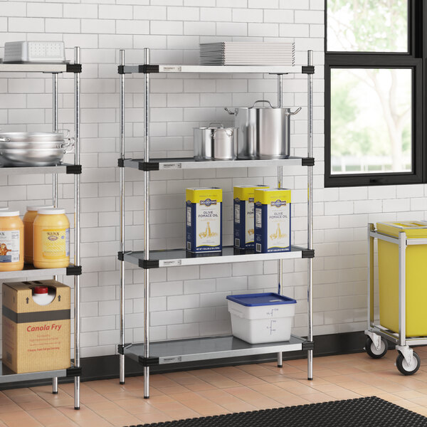 Regency galvanized steel shelves with food containers on them in a kitchen.