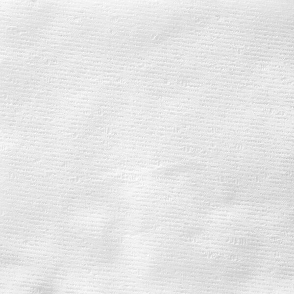 A Charmin Essentials Strong toilet paper mega roll with small lines in the paper.