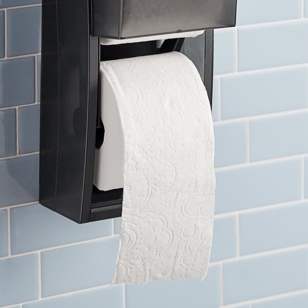 A Charmin Ultra Soft 2-ply toilet paper roll on a black toilet paper holder.