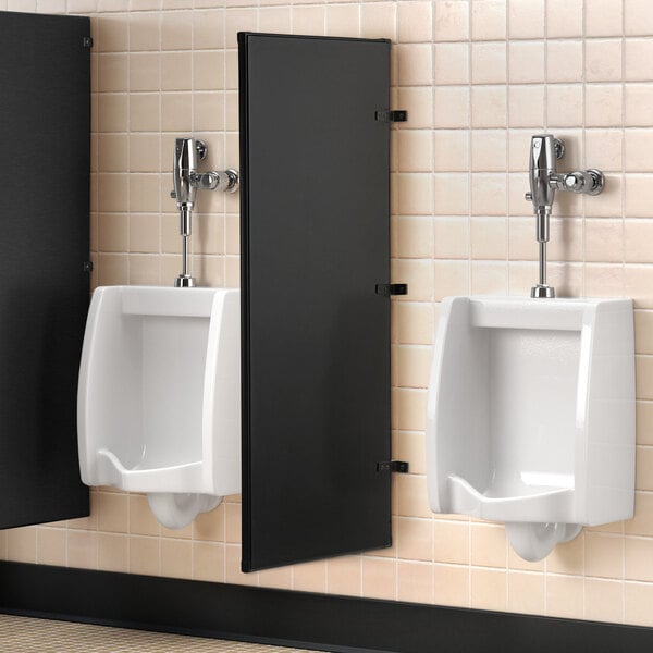 A Lavex matte black steel urinal partition on a wall above a urinal.