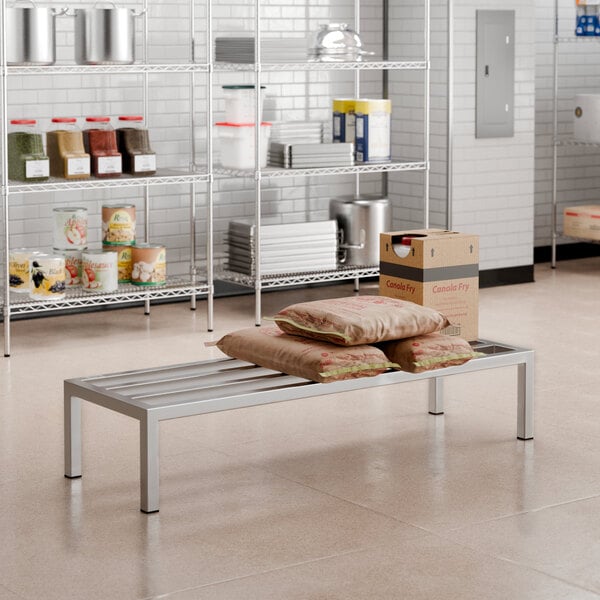 A stack of brown bags on a Regency stainless steel dunnage rack.