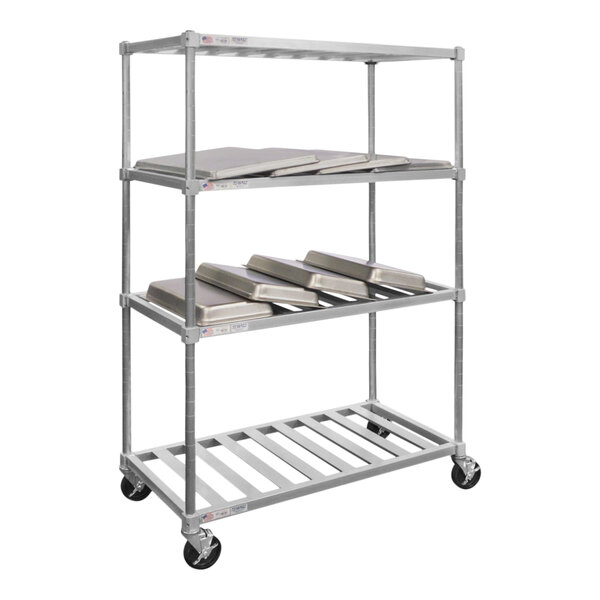 A New Age metal mobile drying rack with metal trays on it.