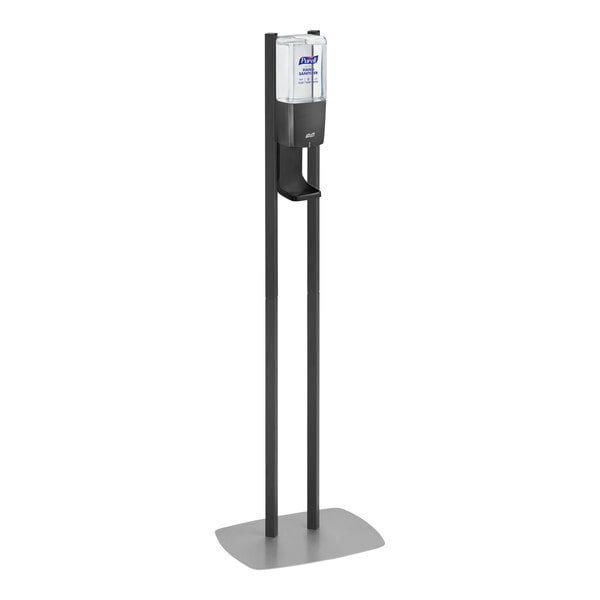 A Purell graphite hand sanitizer dispenser on a white stand.