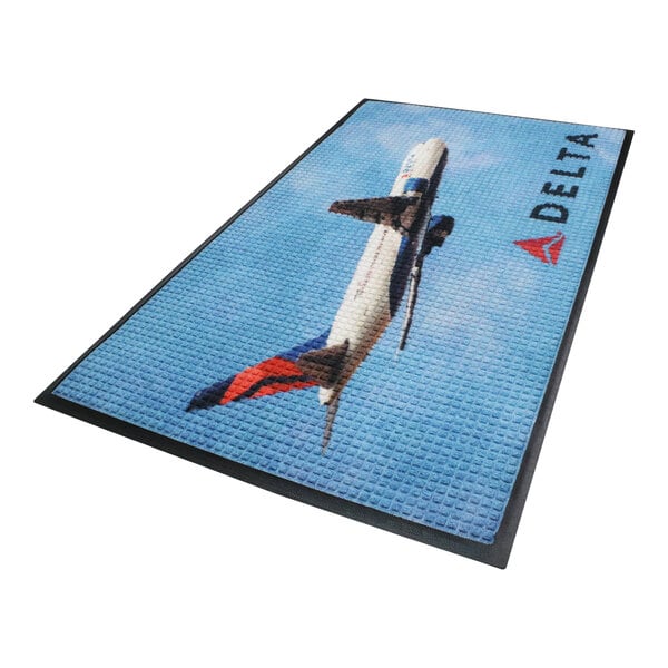 A blue and black rectangular WaterHog Impressions logo mat with a delta logo on it.