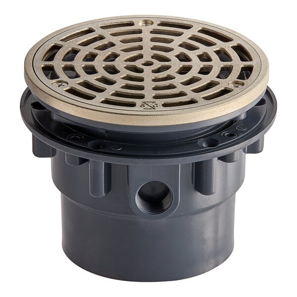 A Sioux Chief round floor drain with a nickel bronze strainer and PVC base.