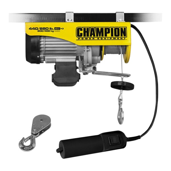 A yellow and black Champion electric hoist with a cable and hook.