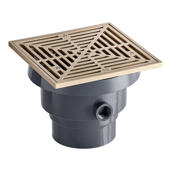 A grey floor drain with a square nickel bronze strainer.
