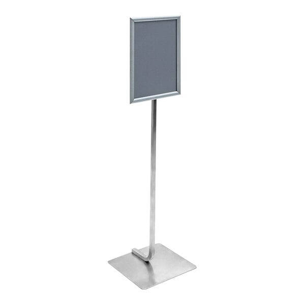 A United Visual Products silver pedestal stand with a snap frame holding a sign.